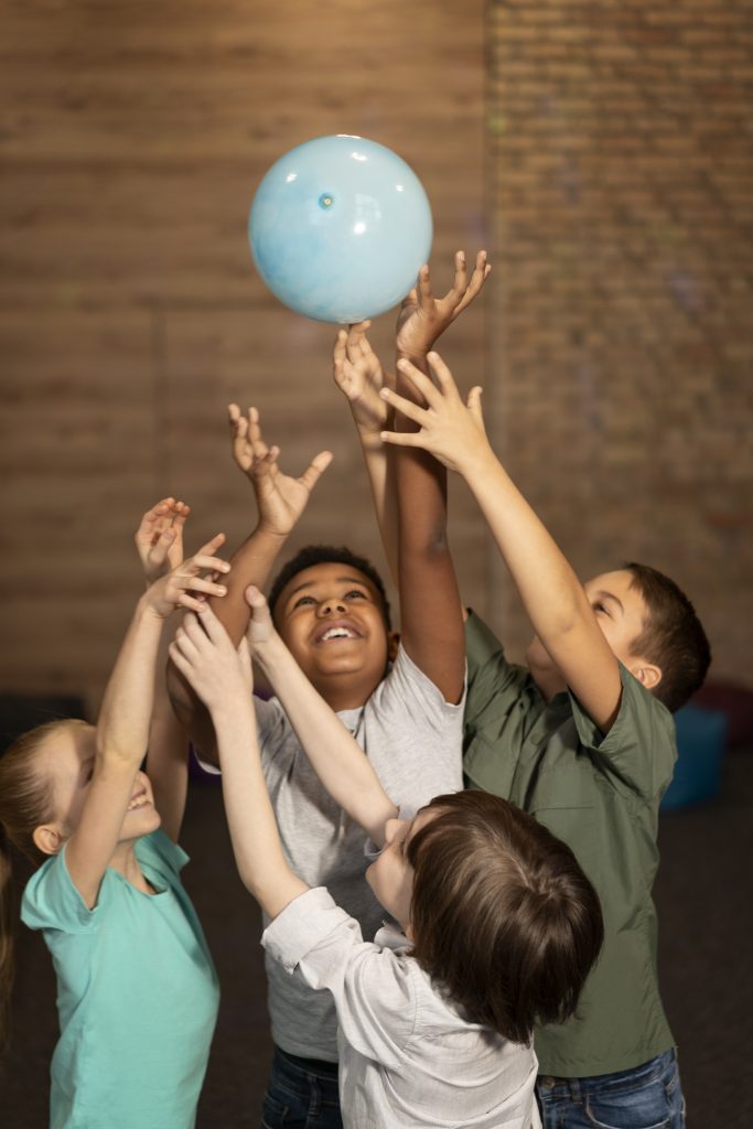 medium shot kids playing with ball