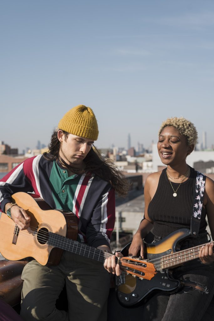 medium shot man woman with guitars